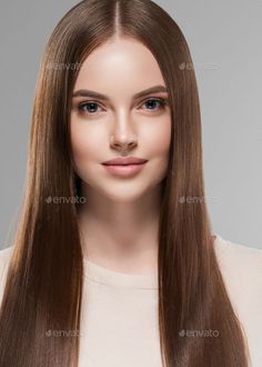 Woman with long brown hair and blue eyes in a studio portrait