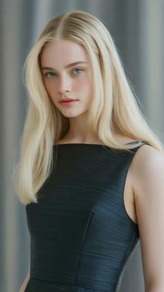 Woman with blonde hair and blue eyes wearing a black dress
