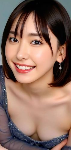 Smiling woman with short dark hair wearing a sequin dress and earrings