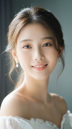 Smiling woman in an off-shoulder dress with pearl earrings