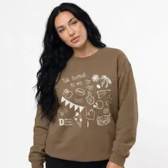 Woman with long dark hair wearing a brown football-themed sweatshirt