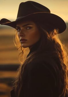 Woman in a cowboy hat with long hair at golden hour