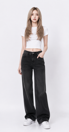 Woman with long blonde hair wearing a white crop top and black jeans