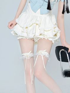 Person in a ruffle skirt, white stockings, and garter belts