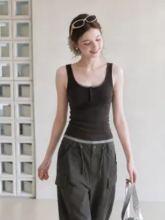 Woman in a brown tank top and cargo pants with sunglasses on her head