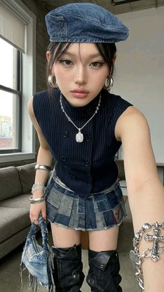 Woman in a denim beret and patchwork denim skirt with silver jewelry