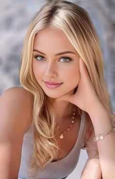 Blonde woman with blue eyes wearing a tank top and jewelry