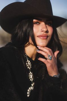 Woman in a cowboy hat and silver jewelry with natural lighting outdoors