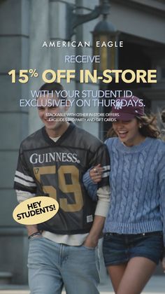Two young people walking on a street, one wearing a Guinness jersey and the other a blue sweater