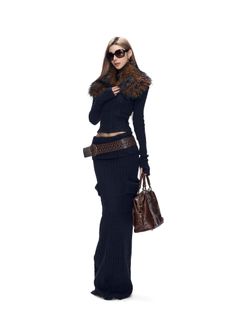 Woman in a knitted dress with a fur collar and sunglasses holding a brown bag