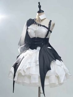 Gothic-style dress with a white ruffled blouse, black corset, and bat wing details on a mannequin