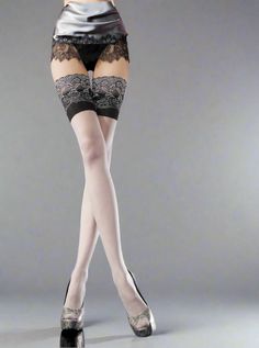 Woman in thigh-high stockings and lingerie with high heels in a studio