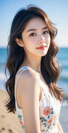 Woman with long brown hair in a floral dress on a beach