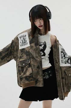 Woman with short hair and headphones wearing a bomber jacket and mini skirt