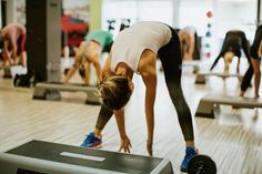 People stretching during a fitness class in a gym