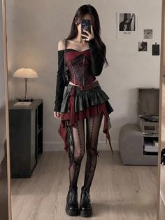 Woman in gothic fashion taking a mirror selfie indoors