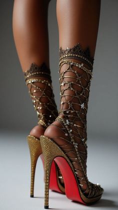 Close up of legs wearing gold jeweled high heels with red soles