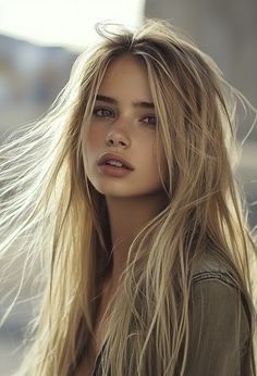 Young woman with long blonde hair in an outdoor portrait with backlight
