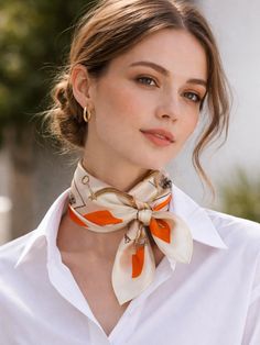 Woman in a white shirt and silk scarf with her hair in an updo