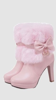 Pair of pink ankle boots with fur trim, a bow, and high heels
