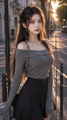 Woman with long dark hair wearing an off-shoulder top and black skirt on a street at golden hour