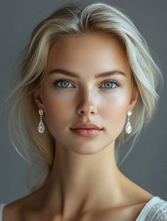 Close-up portrait of a woman with blonde hair and blue eyes wearing earrings