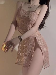 Woman in a sparkly dress with a high slit and long black hair