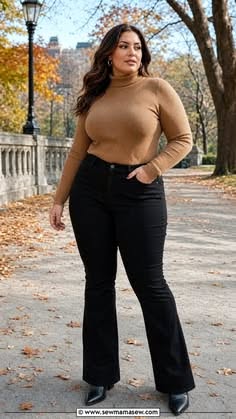 Woman in a brown turtleneck and black pants standing outdoors in autumn