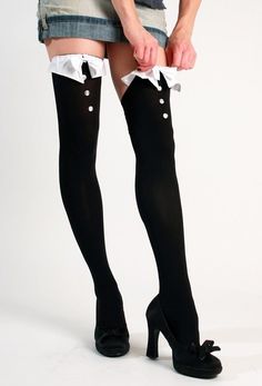 Person in thigh-high socks and a denim skirt adjusting their clothing