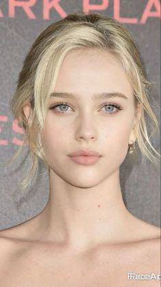 Blonde woman with blue eyes in an upper body portrait with soft lighting