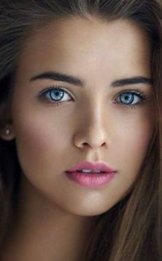 Close up portrait of a woman with blue eyes and pink lipstick