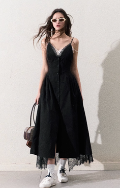 Woman in a black dress with lace trim, white socks, and sunglasses