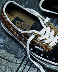 Close up of a Vans shoe with textured fabric and metal studs