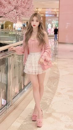 Woman in a pink top and white lace skirt with platform heels in an indoor setting