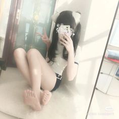 Person with cat ears and pigtails in a white t-shirt and athletic shorts