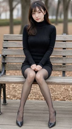 Woman in a black turtleneck dress and pantyhose sitting on a park bench