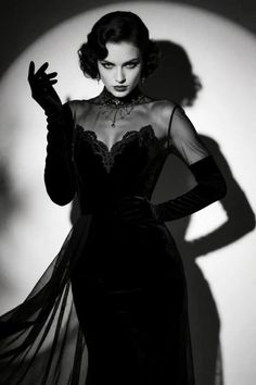 Woman in a black dress and long gloves in dramatic lighting