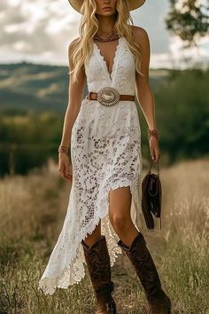 Woman in a white lace dress and cowboy boots in a field