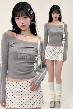 Woman in a gray off-shoulder top and polka dot skirt with leg warmers