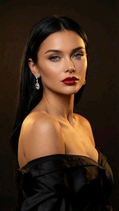 Woman with long black hair and red lipstick wearing an off-shoulder top
