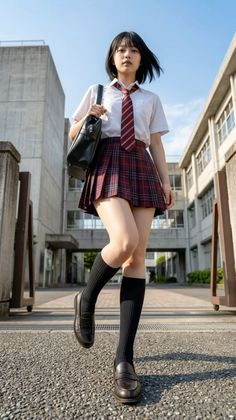 Young woman in a school uniform walking outdoors on a sunny day