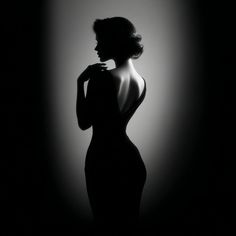 Woman in a black backless dress with dramatic backlight