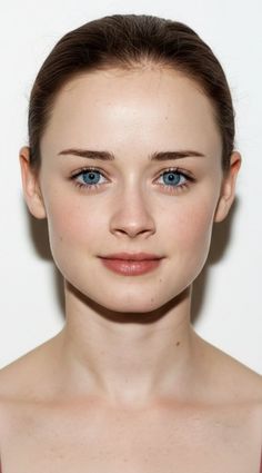 Woman with blue eyes and brown hair pulled back, looking directly at the viewer