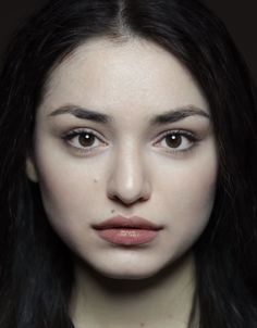 Close up portrait of a woman with dark hair and natural makeup