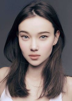 Realistic portrait of a woman with long dark hair and light eyes