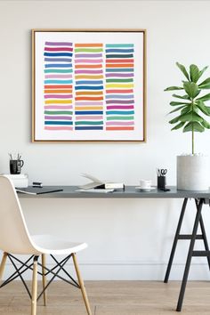 Home office with a colorful abstract art print above a minimalist desk