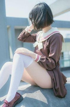 Person in a brown school uniform and white thigh highs sitting outdoors