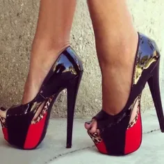 Woman wearing black patent leather platform high heels with red soles and leopard print