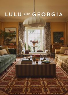 A cozy living room with a bay window, two sofas, and a large coffee table
