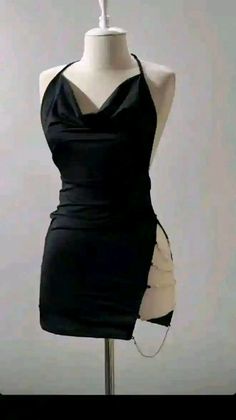 Black halter neck dress with a draped neckline and chain detail on a mannequin